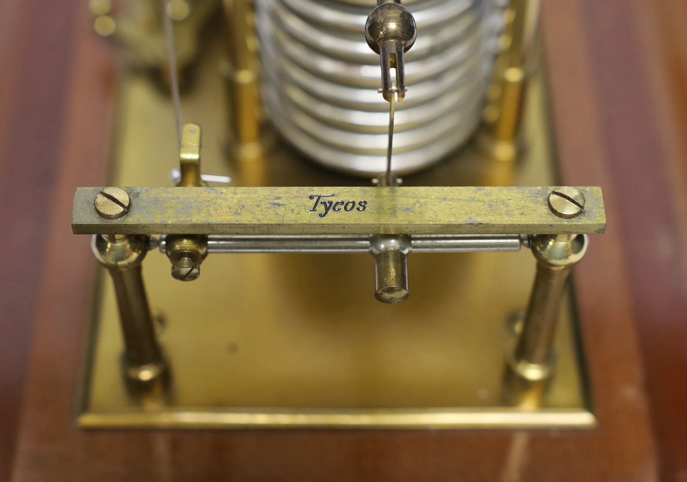A 20th century barograph by Tycos, in a mahogany case with bevelled glass panels and incorporating an ink bottle and a drawer with spare graph papers, 36.5cm x 21.5cm
